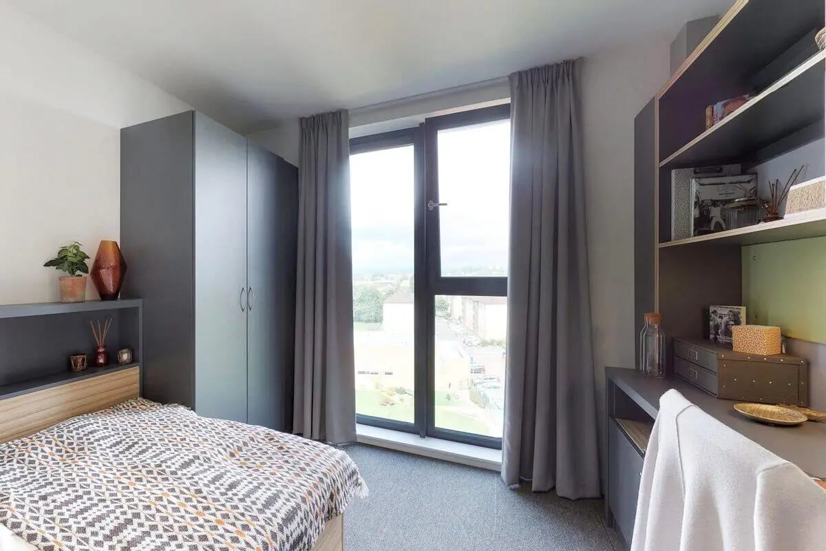 Bed wardrobe desk and large window Bedroom at St James Glasgow in Glasgow Student Accommodation