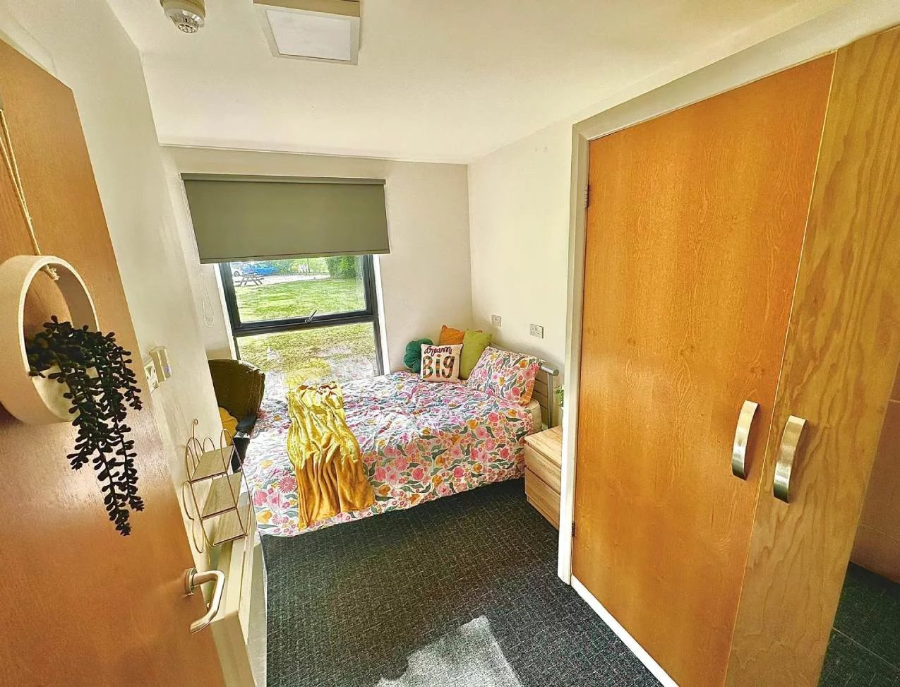 Bed with floral bedding and throw bedroom at Forest Court in Loughborough Student Accommodation
