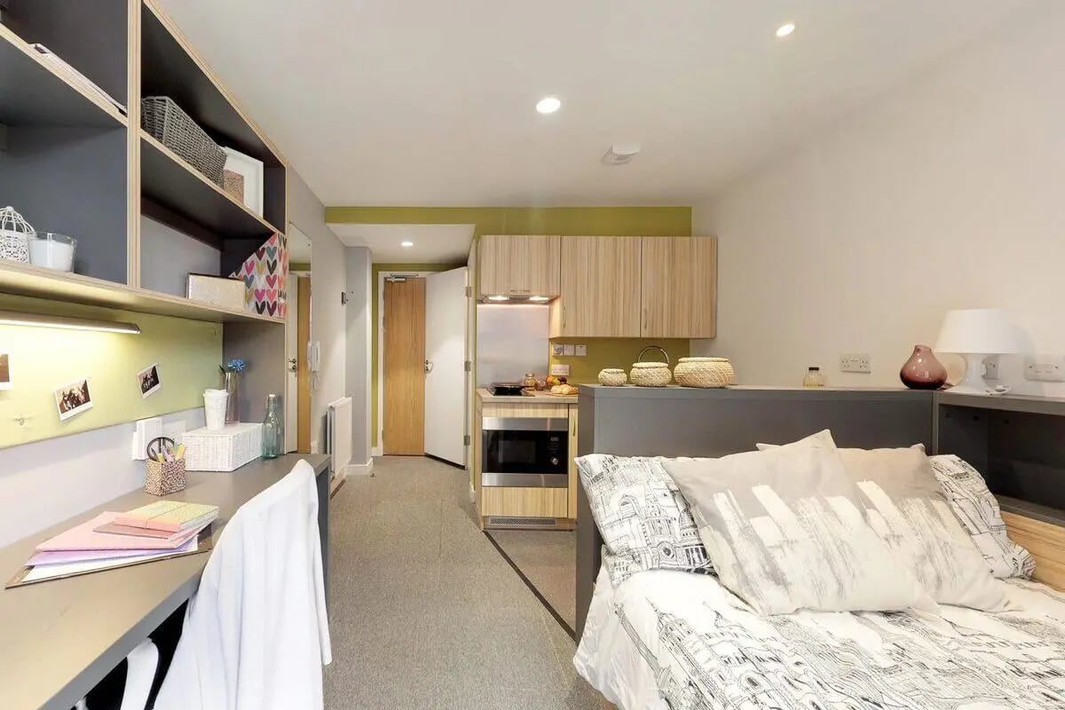 Desk bed kitchen and shelving student studio room at St James Glasgow in Glasgow Student Accommodation