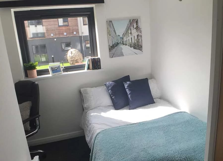Bed with blue pillows and light blue throw Bedroom at Forest Court in Loughborough Student Accommodation