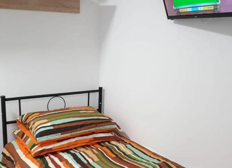 Bed with striped pillows black frame bedroom at Salisbury Road in Leicester Student Accommodation