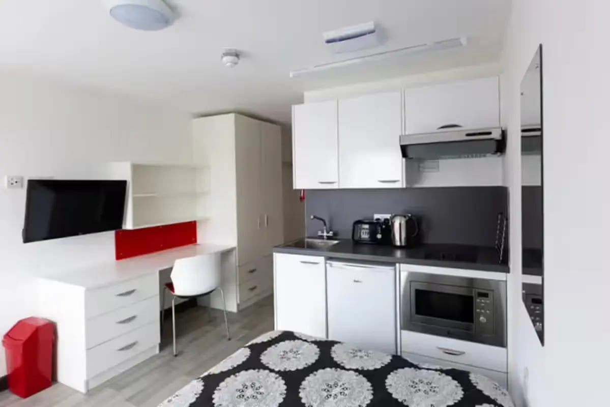 Bed desk television kitchen with appliances studio room at Julian Court in Coventry Student Accommodation