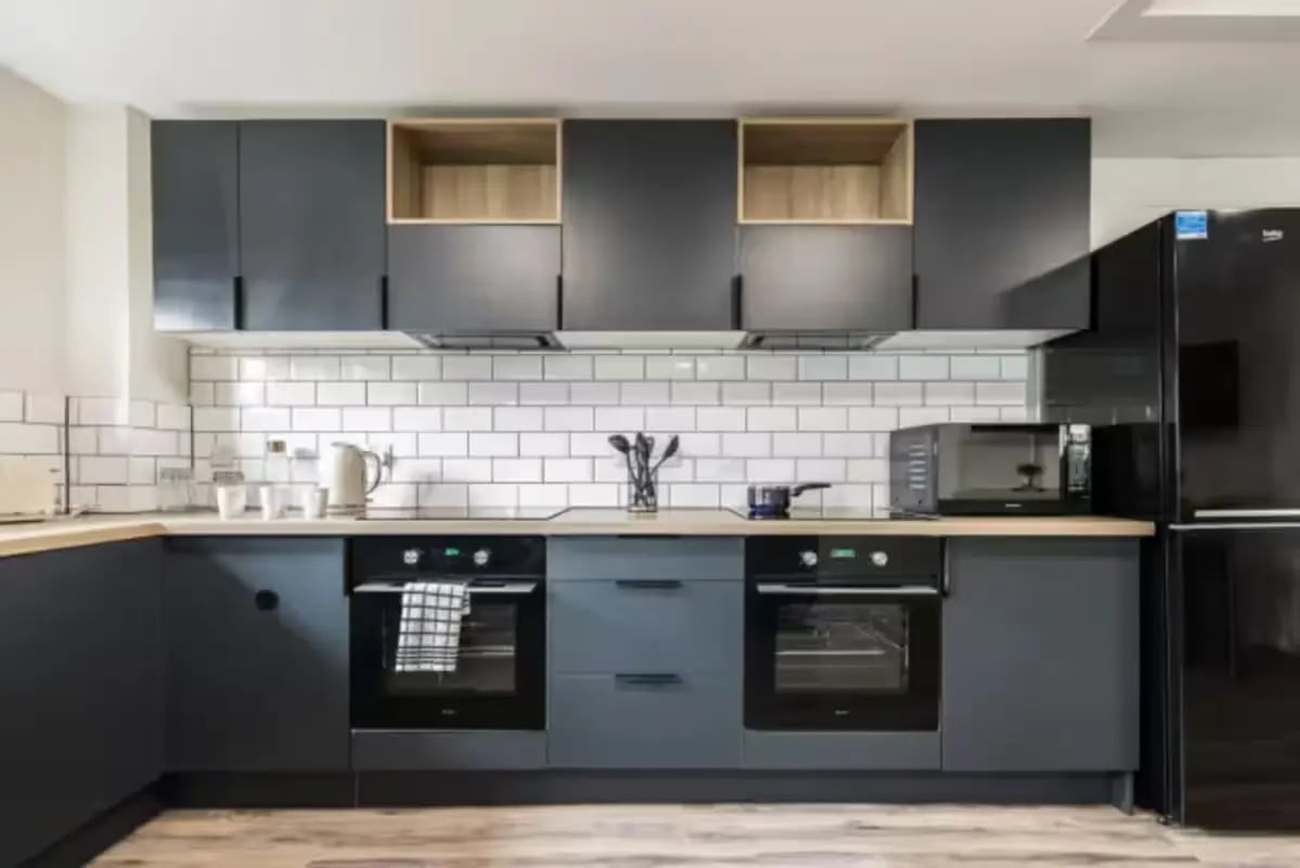 Two ovens kettle microwave black cabinets kitchen at Meadowside Court in Dundee Student Accommodation