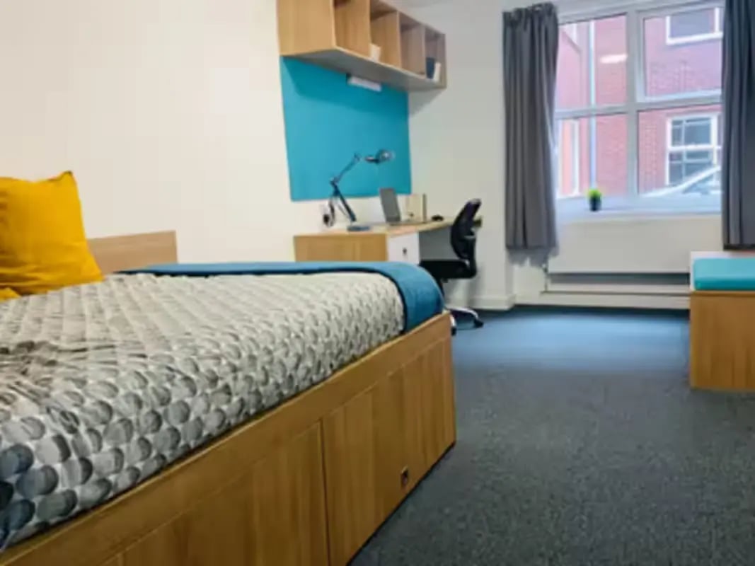 Bed desk chair and shelves bedroom at Pennine House Leicester in Leicester Student Accommodation