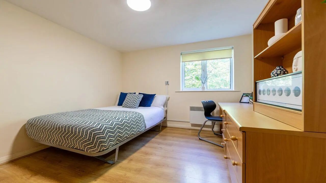Bed desk chair and shelf bedroom at Weston Court in Manchester Student Accommodation