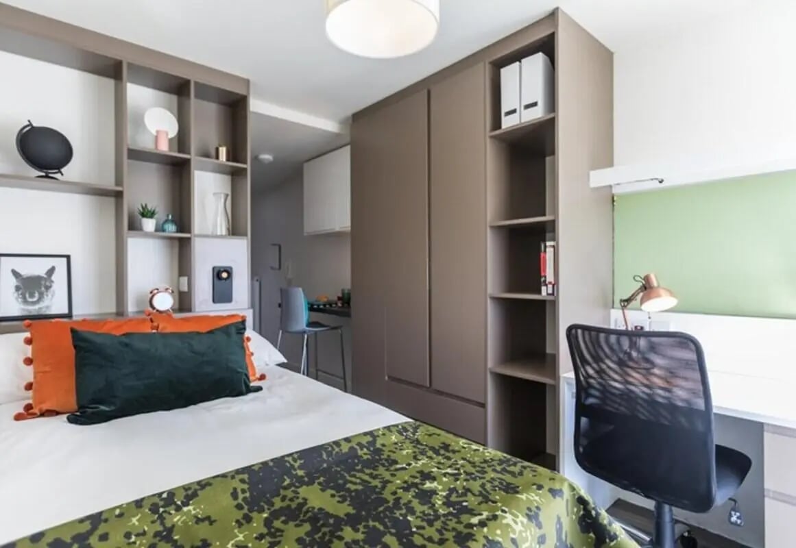 Bed with pillows desk chair and shelves bedroom at Aparto Arbury Court in Kingston Upon Thames Student Accommodation