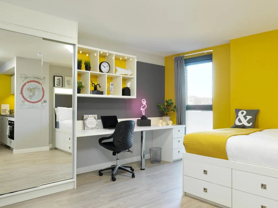 Desk bed shelves and kitchen area student room at Student Castle Edinburgh in Edinburgh Student Accommodation