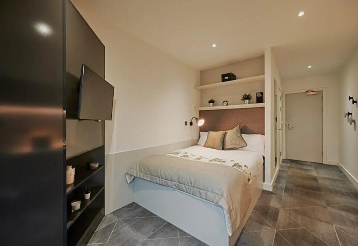 Bed TV shelves and door bedroom at aparto Glasgow West End in Glasgow Student Accommodation