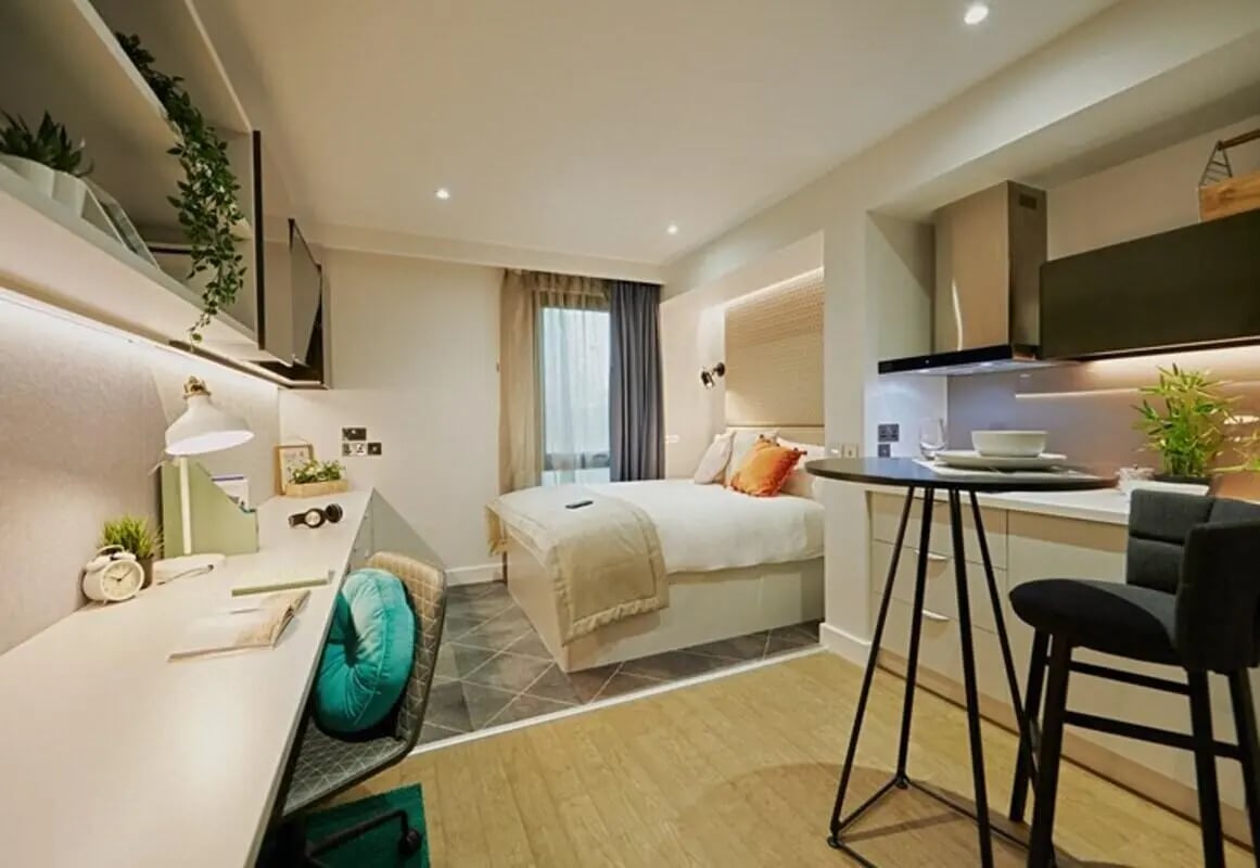 Bed desk kitchen area bar stool and bed bedroom at aparto Glasgow West End in Glasgow Student Accommodation