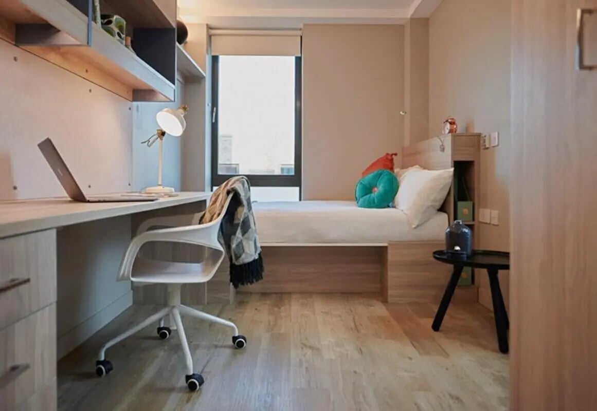 Bed desk chair laptop and shelves bedroom at Caton Court in Lancaster Student Accommodation