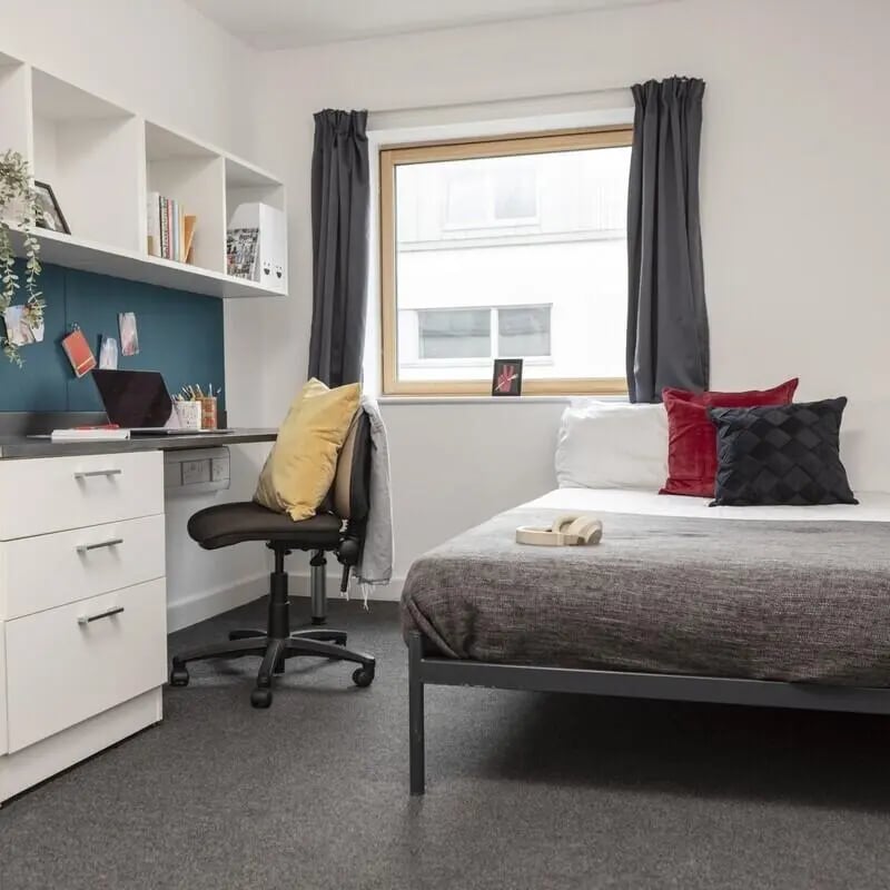 Desk chair bed shelves window pillows Bedroom at Fitzroy Court in Luton Student Accommodation