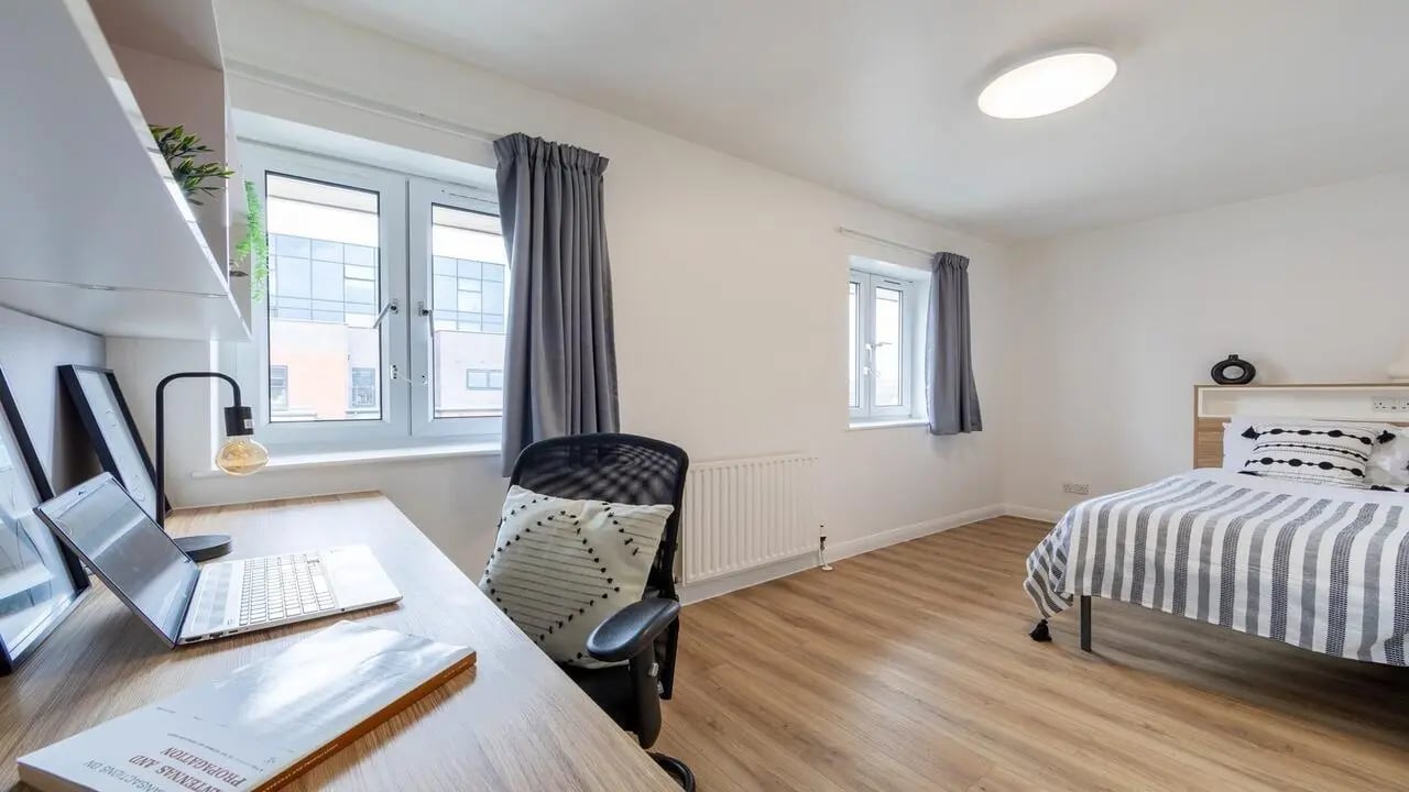 Desk chair laptop bed window bedroom at MSV South in Manchester Student Accommodation