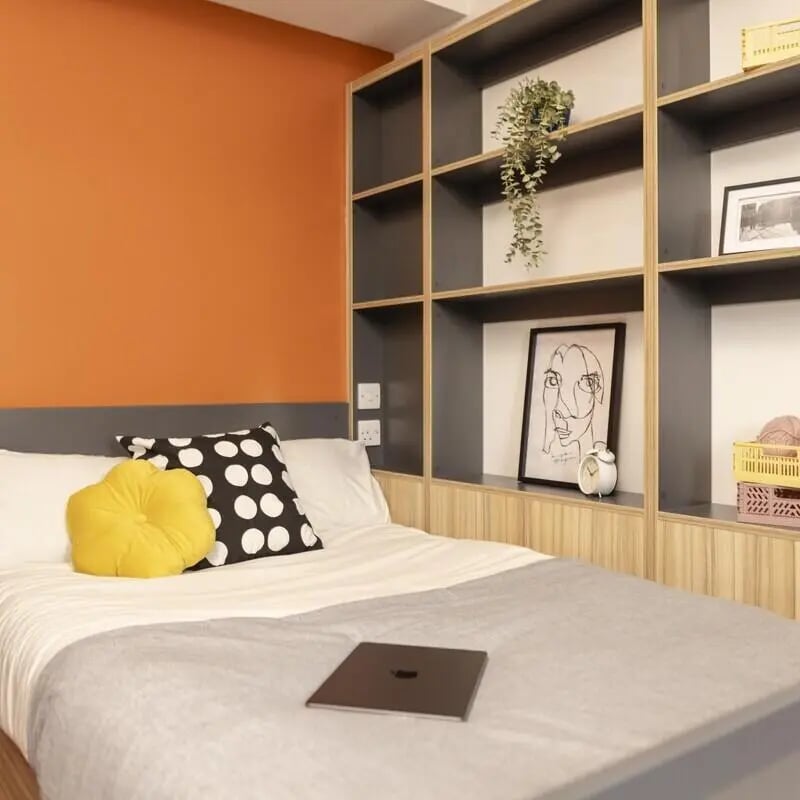 Bed pillows laptop shelves art bedroom at Peel Park Quarter in Salford Student Accommodation