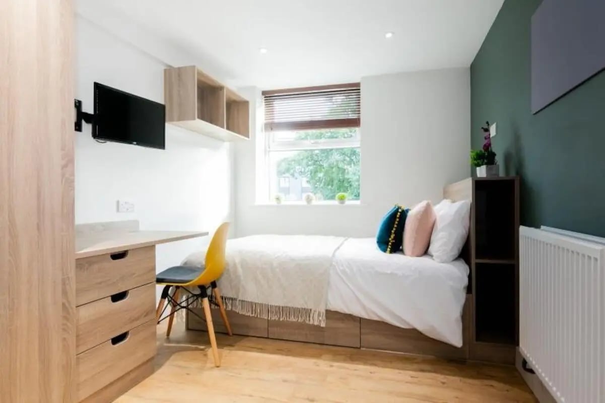 Bed desk TV chair and shelves bedroom at Bankfield in Huddersfield Student Accommodation