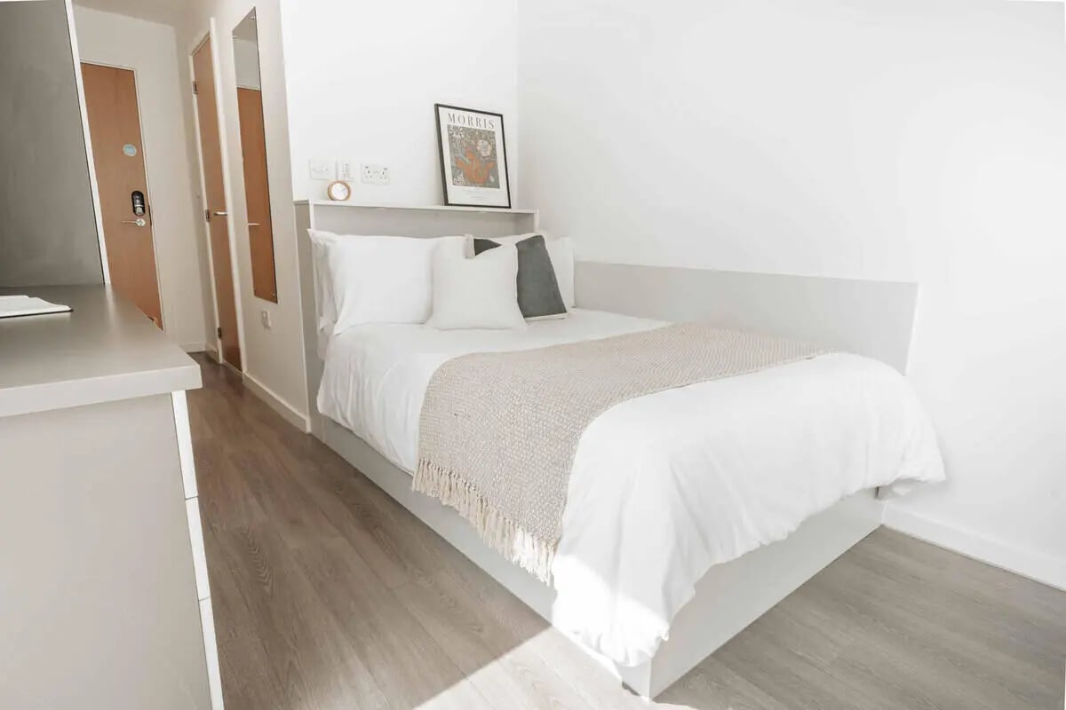 Bed with white linens and throw Bedroom at Market House in Newcastle Upon Tyne Student Accommodation