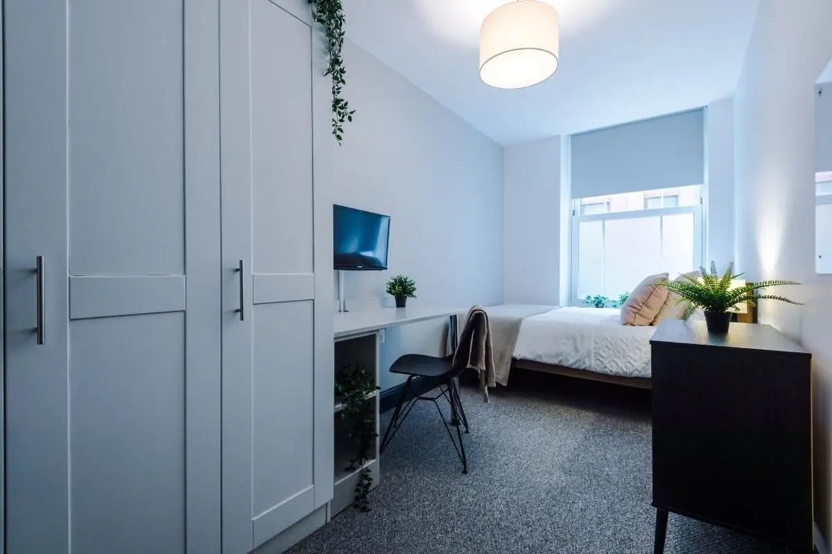 Wardrobe desk chair bed dresser plants bedroom at The Shoe & Boot Factory in Leicester Student Accommodation