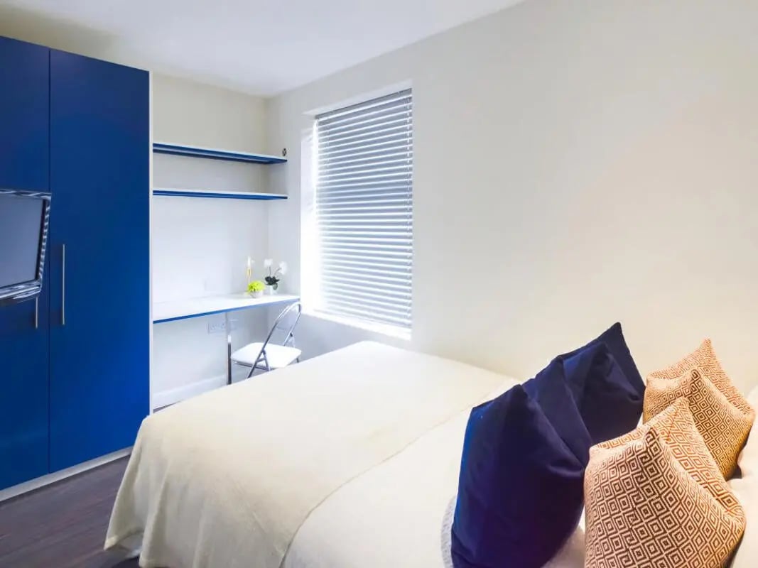 Blue wardrobe desk shelves chair bed bedroom at 23 Carlton Road in Stoke-On-Trent Student Accommodation