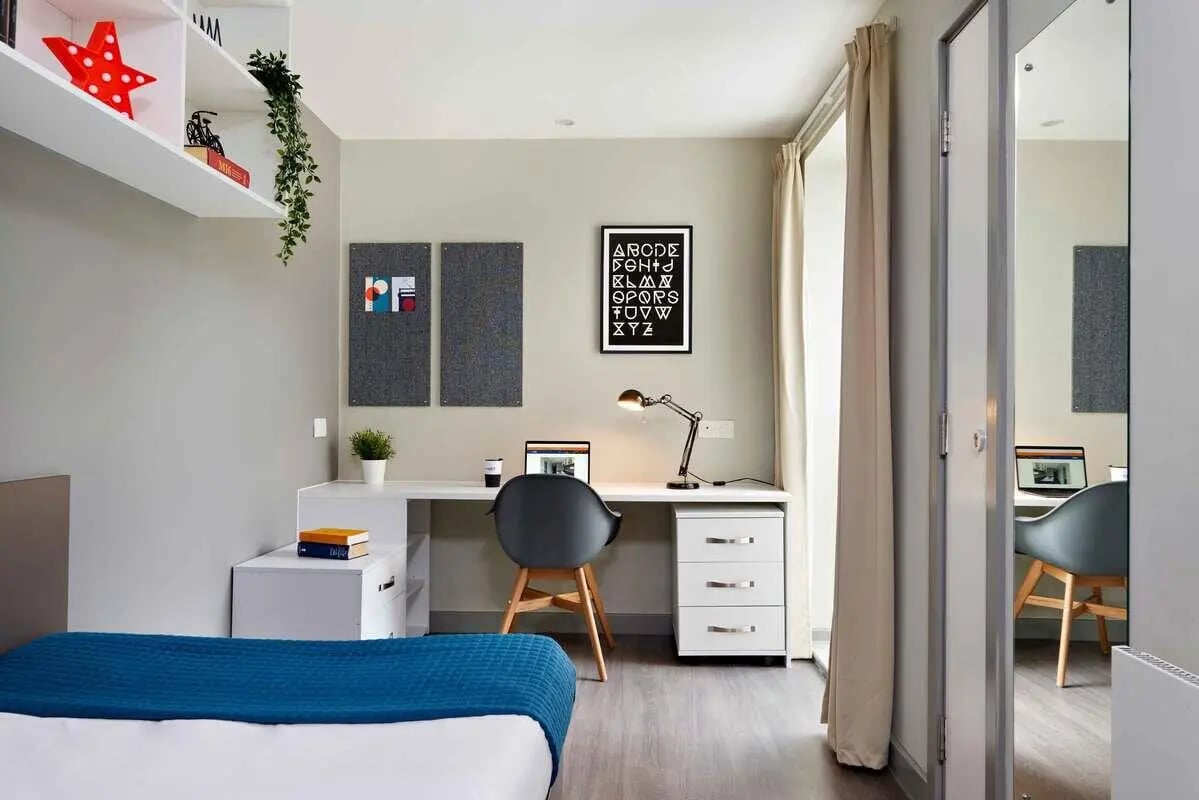 Desk with laptop chair and bed Bedroom at Saw Mill in Huddersfield Student Accommodation