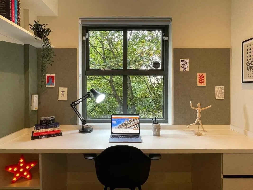 Desk with laptop lamp books and art study area at Firth Point in Huddersfield Student Accommodation