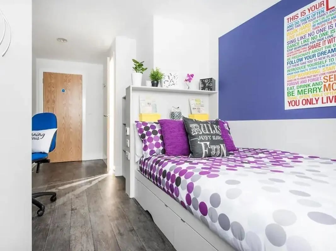 Bed with purple pillows and polka dot bedding Bedroom at Yugo Ablett House in Liverpool Student Accommodation