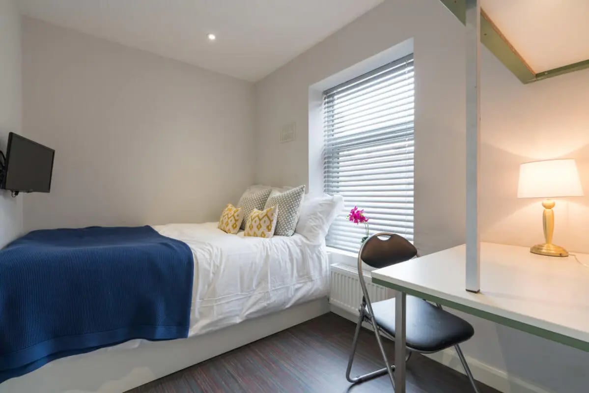 Bed TV desk lamp and chair bedroom at 85 Seaford Street in Stoke-On-Trent Student Accommodation