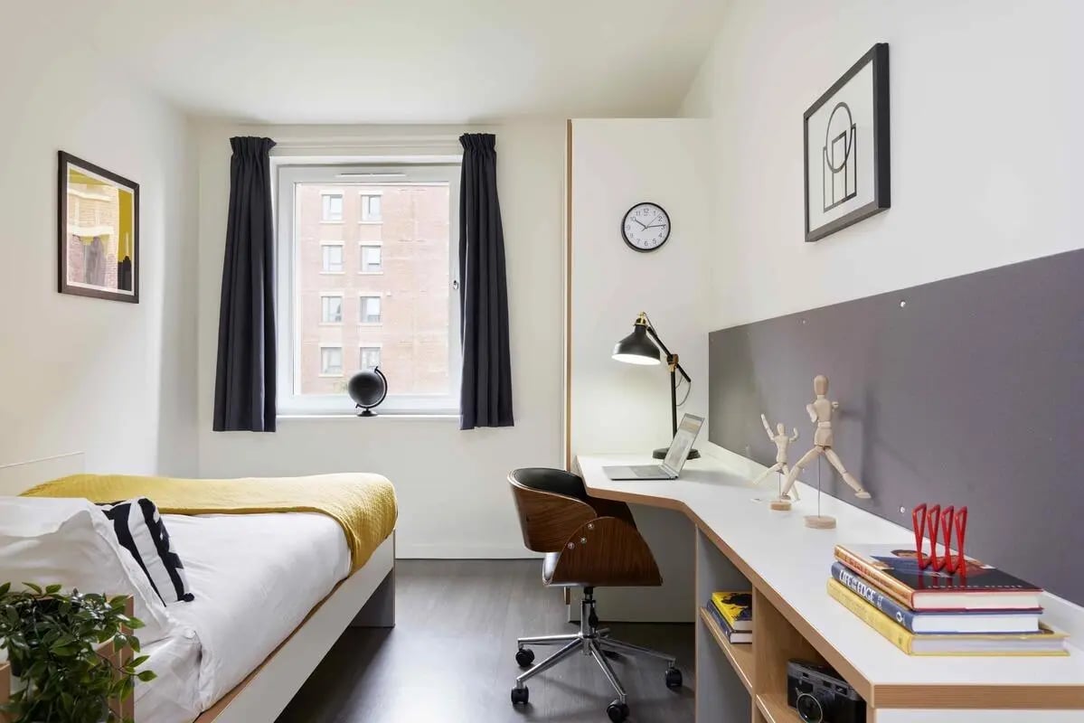 Bed desk lamp chair and globe bedroom at Asa Briggs House in Leeds Student Accommodation