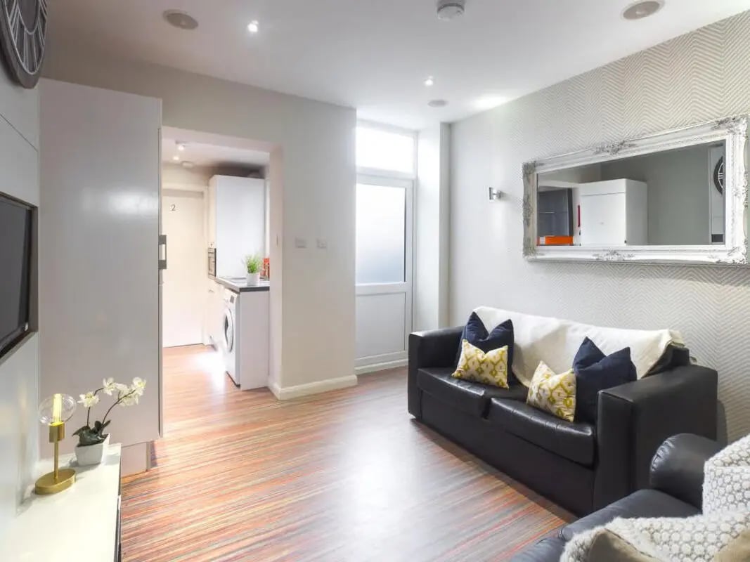 Black sofa patterned pillows modern living room at 93 Thornton Road in Stoke-On-Trent Student Accommodation
