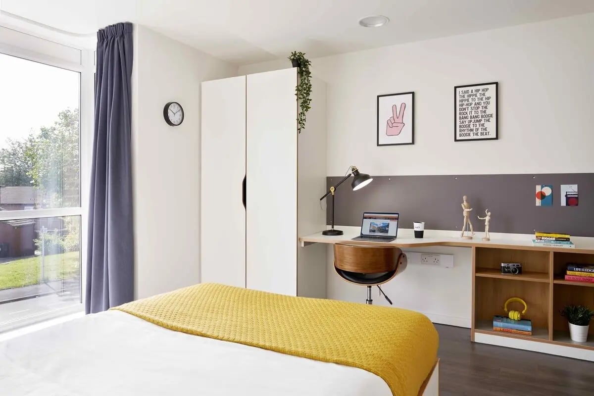 Bed wardrobe desk chair and shelving bedroom at Asa Briggs House in Leeds Student Accommodation
