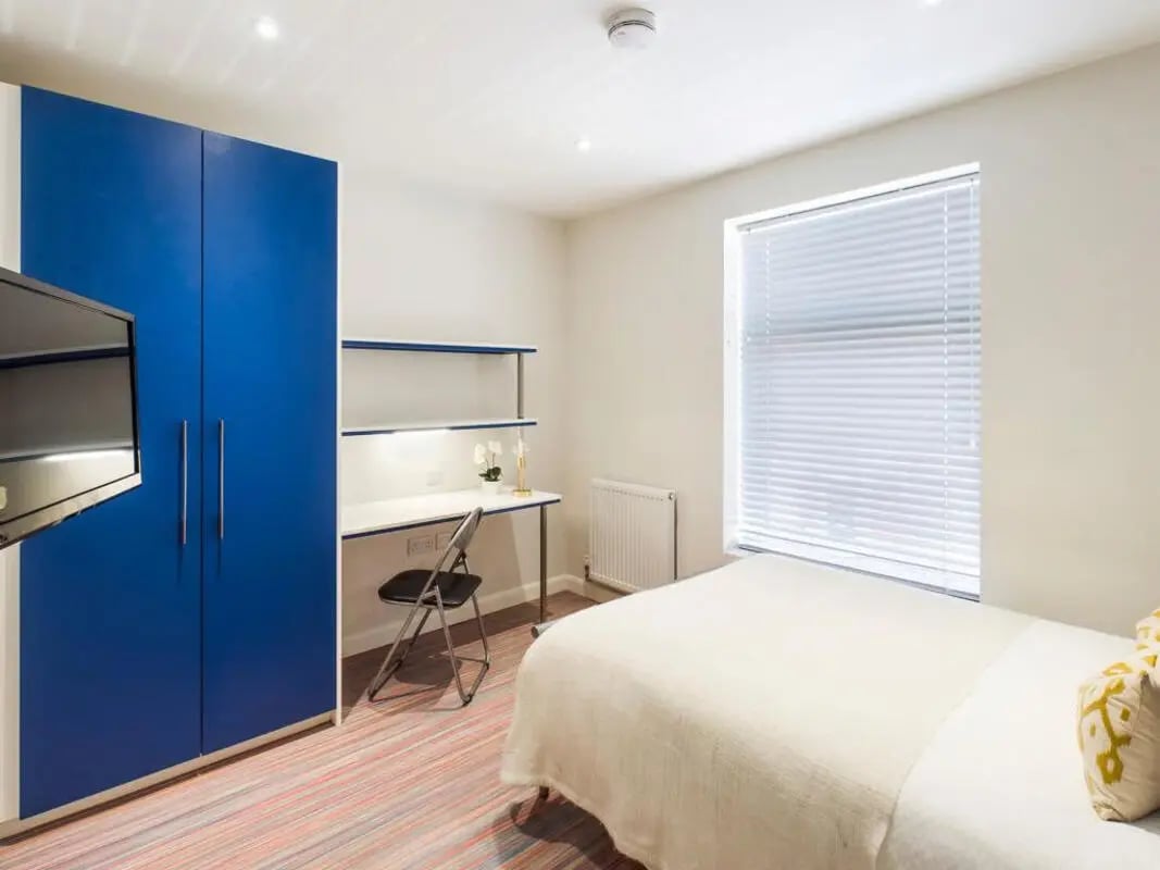 Blue wardrobe white desk bed with pillows Bedroom at 41 Crowther Street in Stoke-On-Trent Student Accommodation