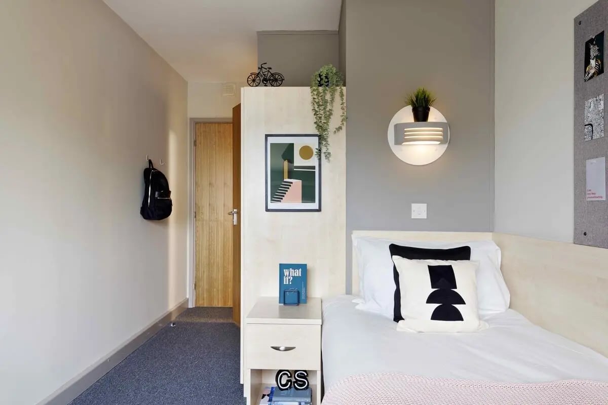 Bed with pillows and bedside table bedroom at Alexandra Works in Plymouth Student Accommodation