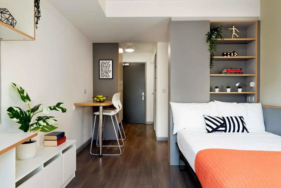 Bed desk plant and shelves bedroom at Hampton Square in Southampton Student Accommodation