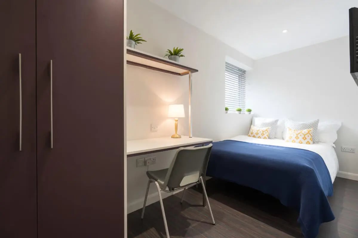 Wardrobe desk chair lamp and bed bedroom at 16 Queen Anne Street in Stoke-On-Trent Student Accommodation