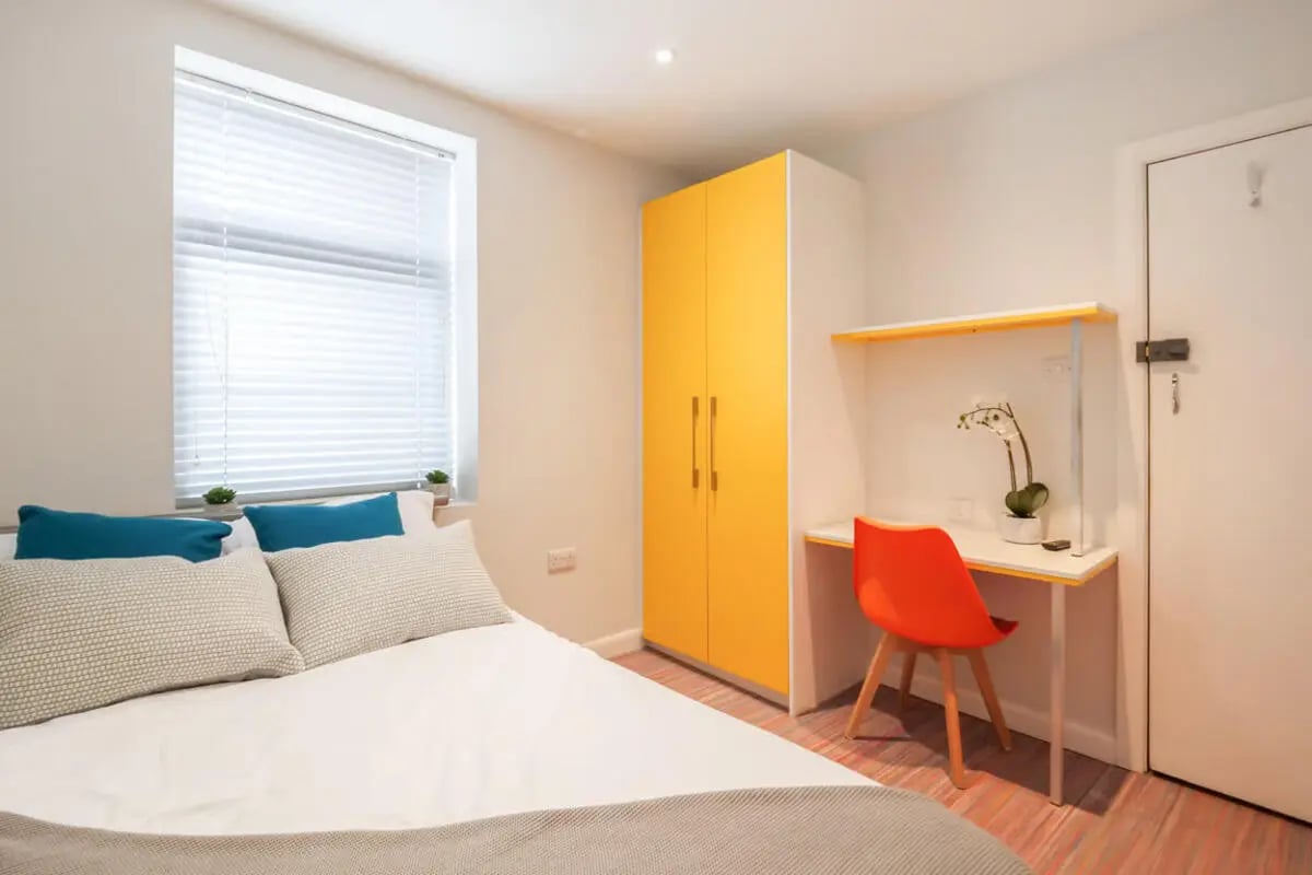 Bed desk wardrobe with orange chair bedroom at 64 Seaford Street in Stoke-On-Trent Student Accommodation