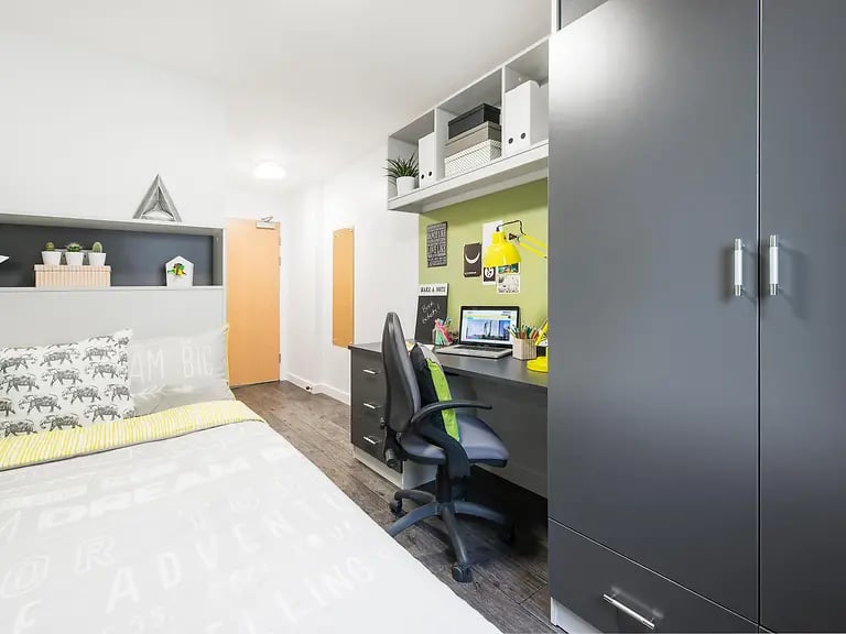 Bed desk chair laptop and wardrobe bedroom at Yugo Crescent Place in Southampton Student Accommodation