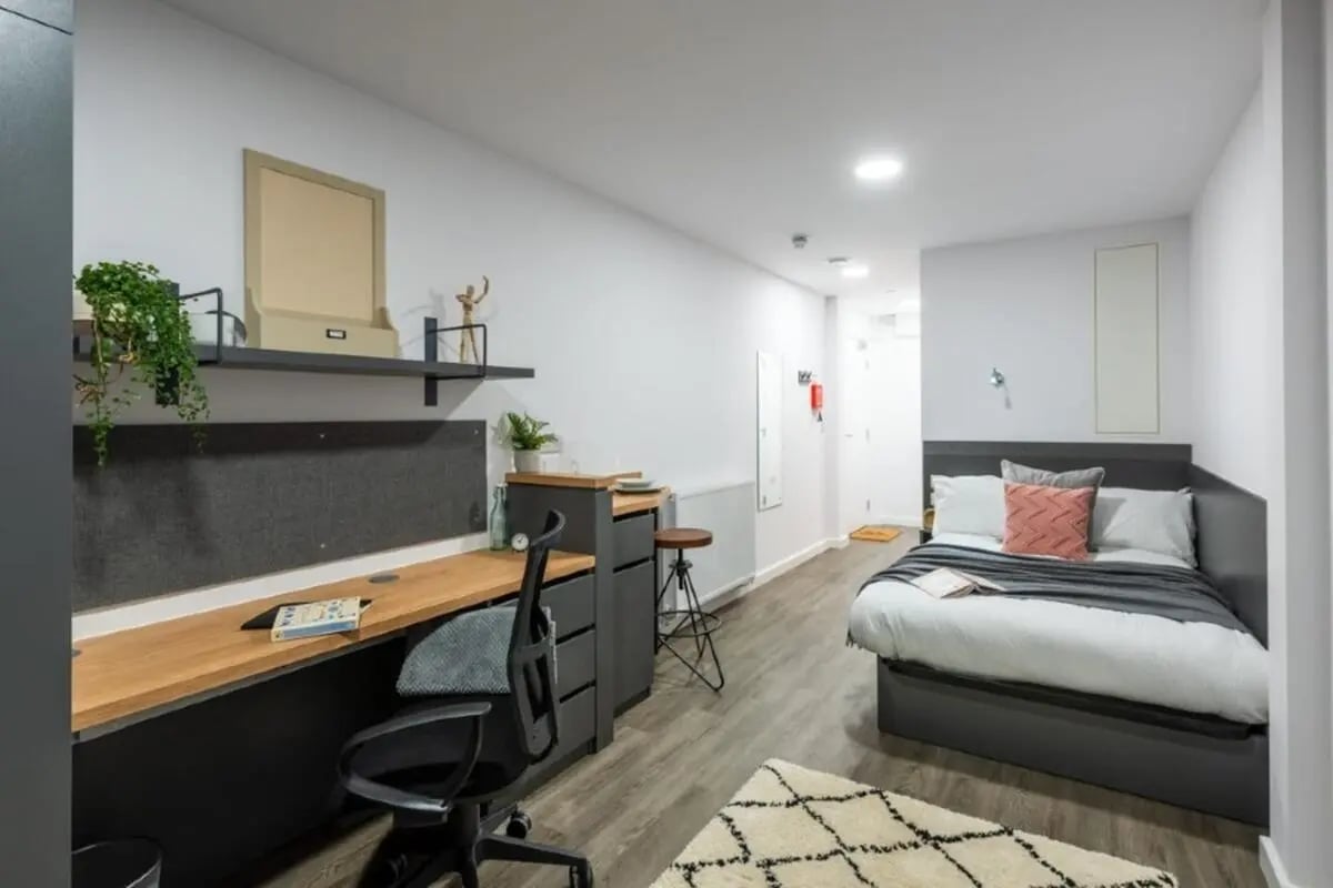 Bed desk shelf and rug student studio bedroom at The Valentine London in London Student Accommodation