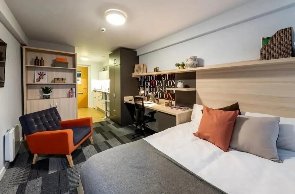 Bed desk chair shelves and kitchenette studio apartment at The Electra in Liverpool Student Accommodation