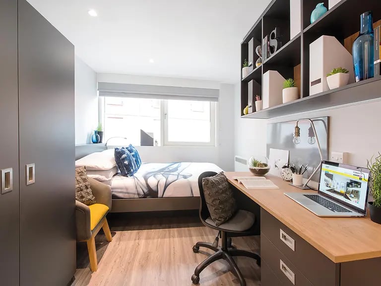 Bed desk chair closet and shelving bedroom at Yugo Therese House in London Student Accommodation