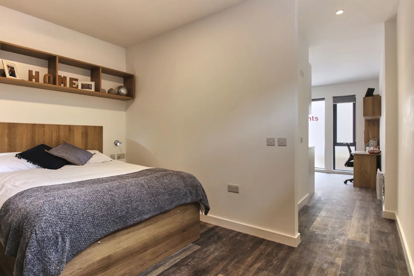 Bed with shelves and desk area bedroom at City Heights - Cardiff in Cardiff Student Accommodation