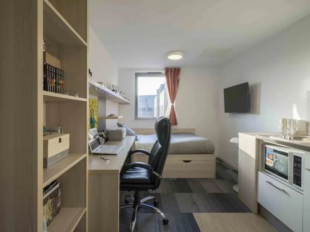 Desk bed microwave and shelves student studio at The Railyard Cambridge in Cambridge Student Accommodation