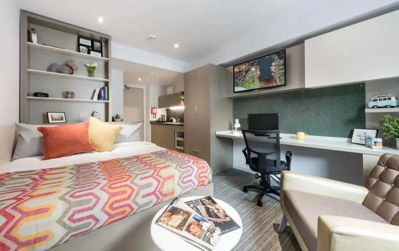 Bed desk TV chair kitchen area bedroom at The Kingfisher in Exeter Student Accommodation