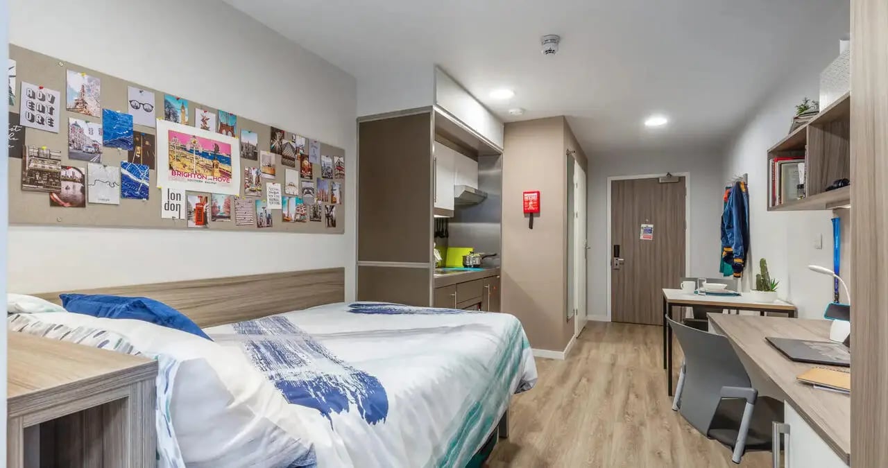 Bed kitchen desk and wall decor studio at Kaplan Living Brighton in Brighton Student Accommodation