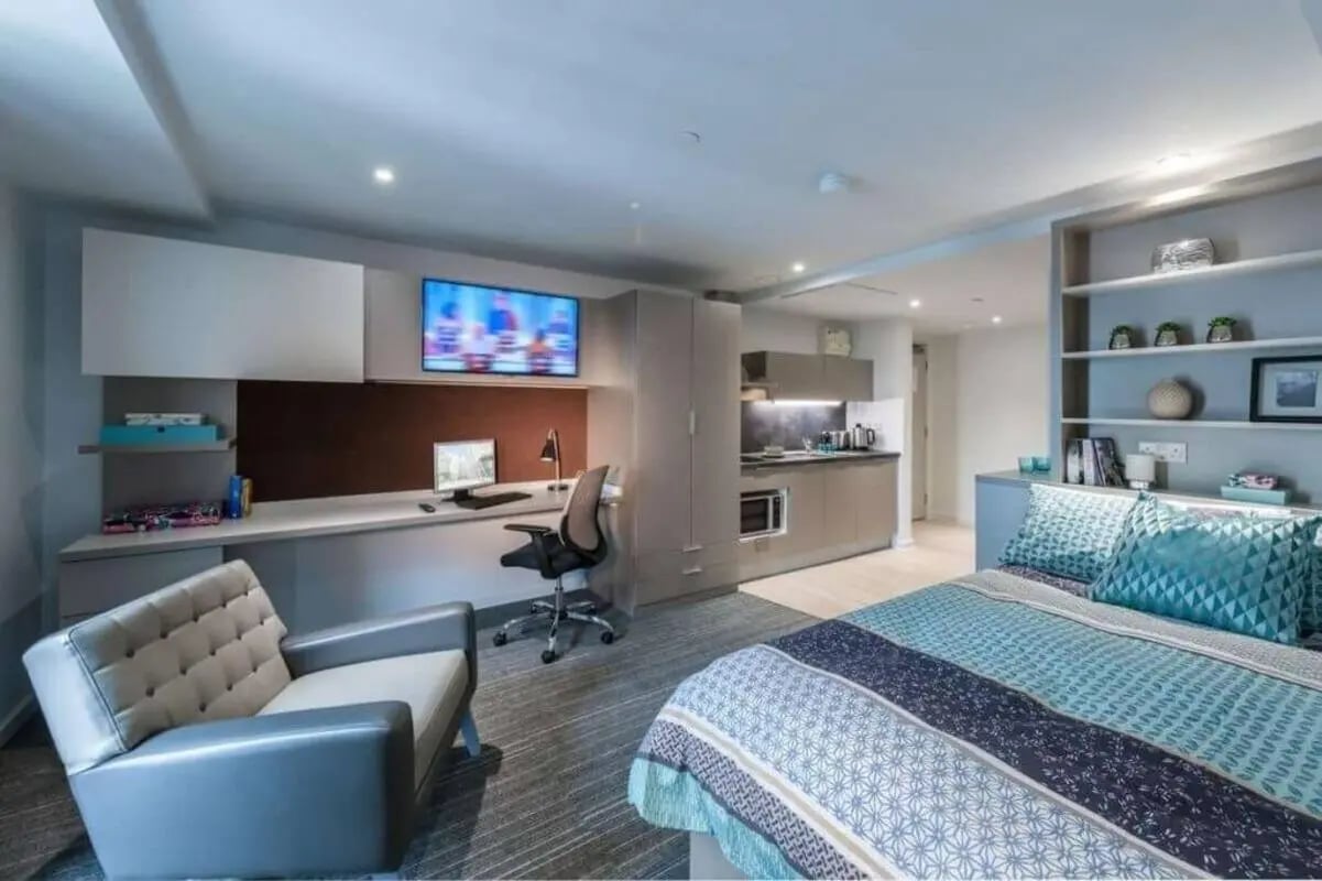 Bed desk chair sofa kitchen studio apartment at CitySide in Leeds Student Accommodation