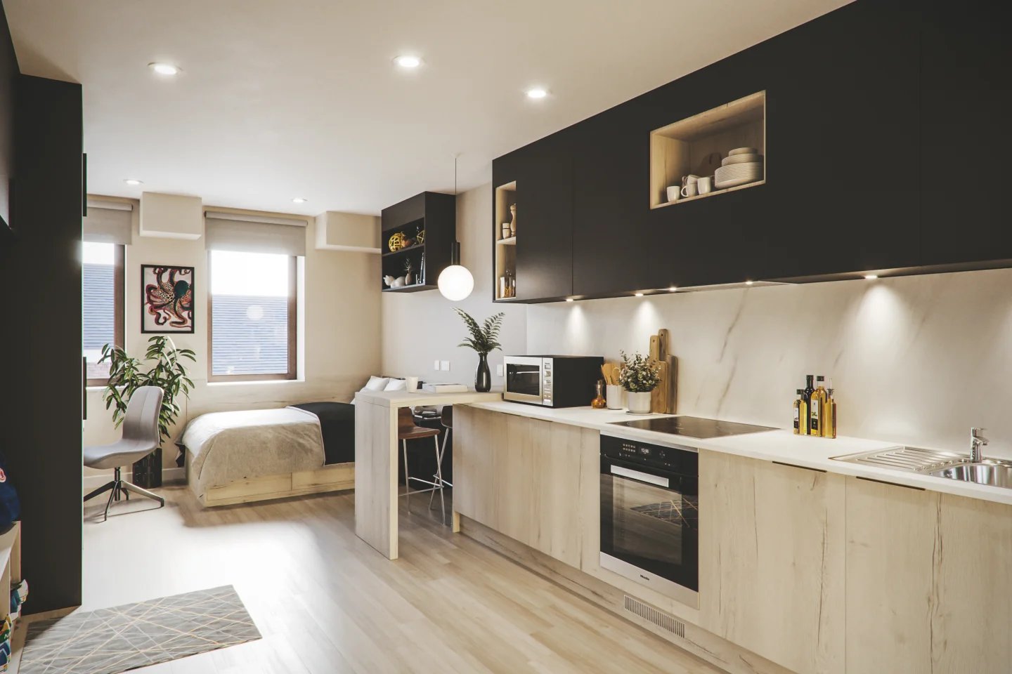 Bed kitchen and desk area studio apartment at Briggate Studios in Leeds Student Accommodation