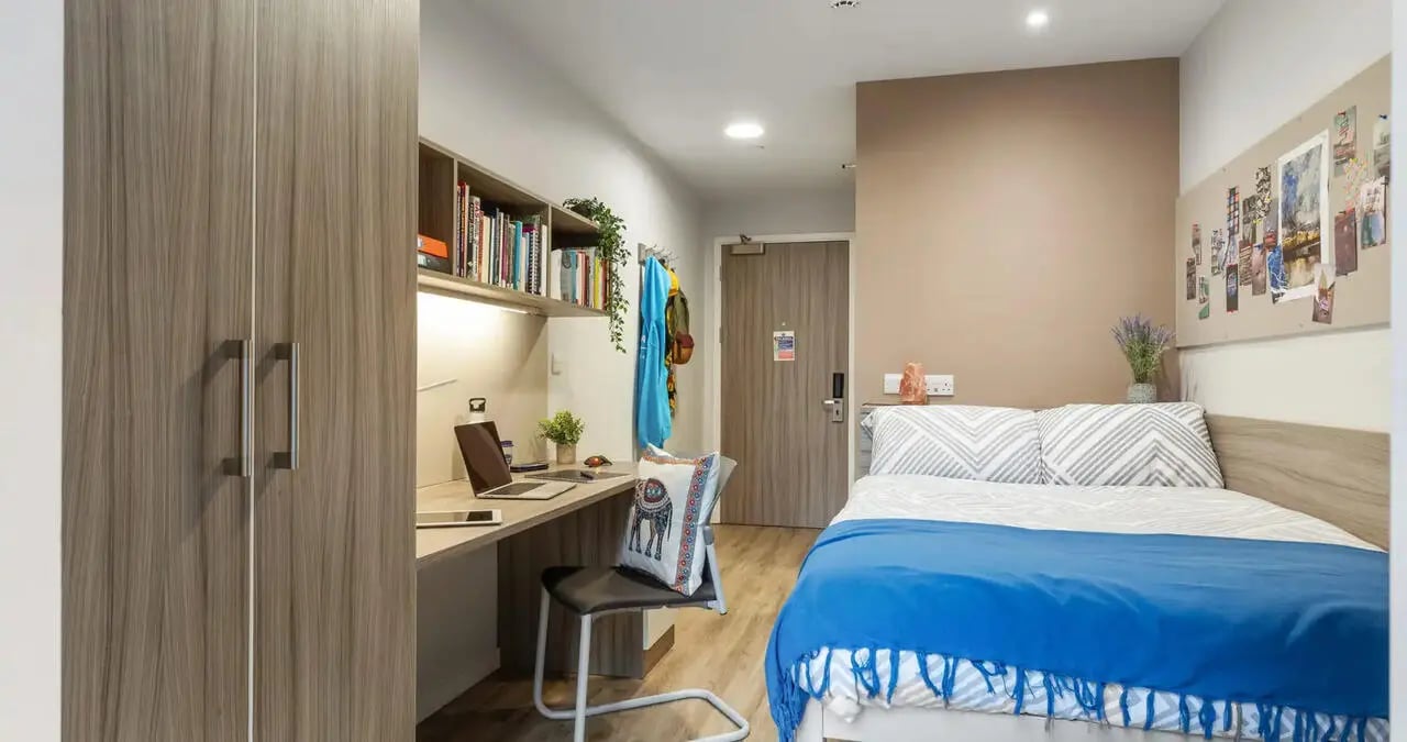 Closet desk laptop bed and chair Bedroom at Kaplan Living Brighton in Brighton Student Accommodation
