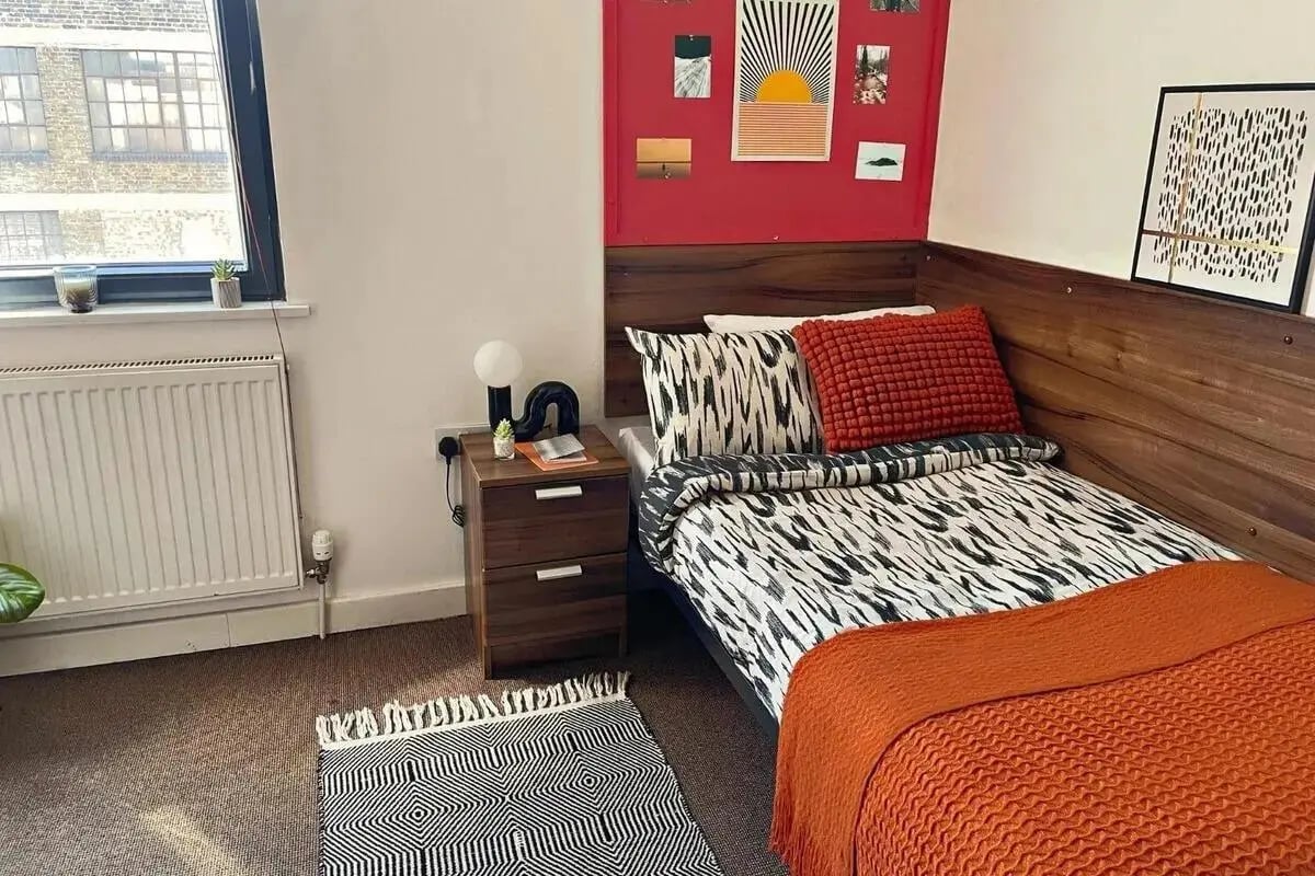 Bed bedside table rug and art bedroom at The Craft Building in London Student Accommodation