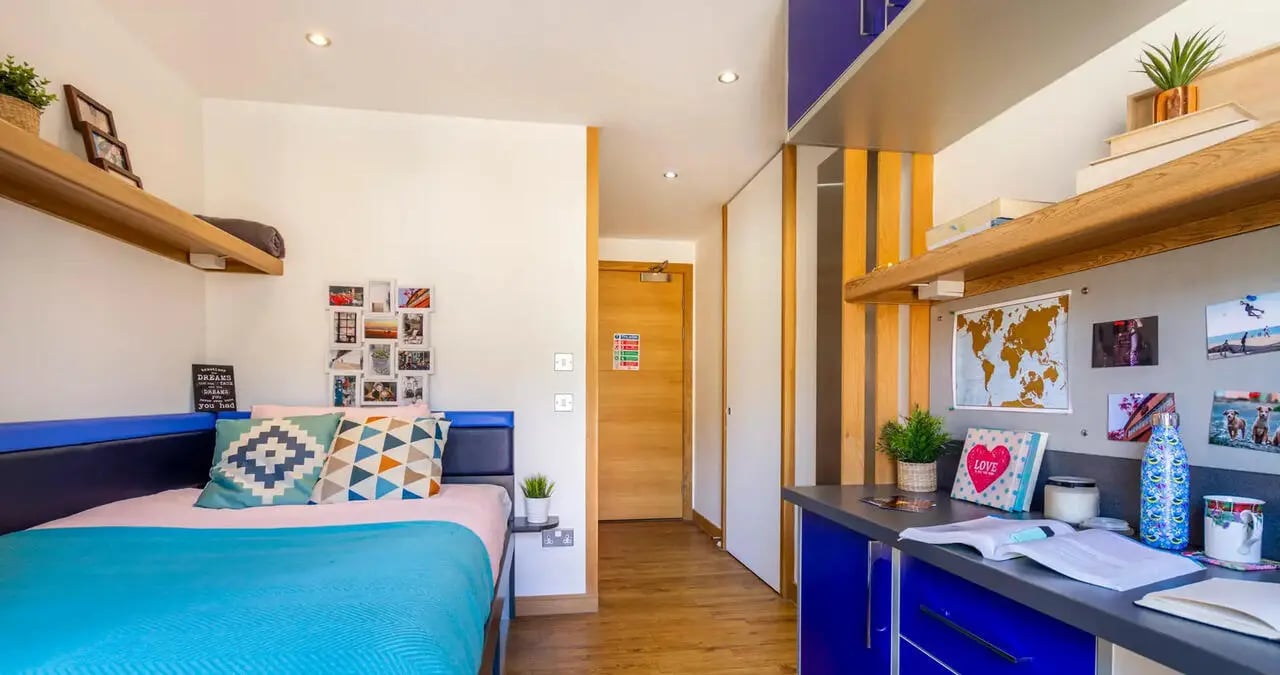 Bed desk with map photos and plant bedroom at Kaplan Living Glasgow - Argyle Street in Glasgow Student Accommodation