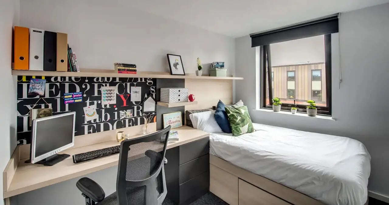 Desk bed monitor chair and shelves bedroom at Kaplan Living West Village in Glasgow Student Accommodation
