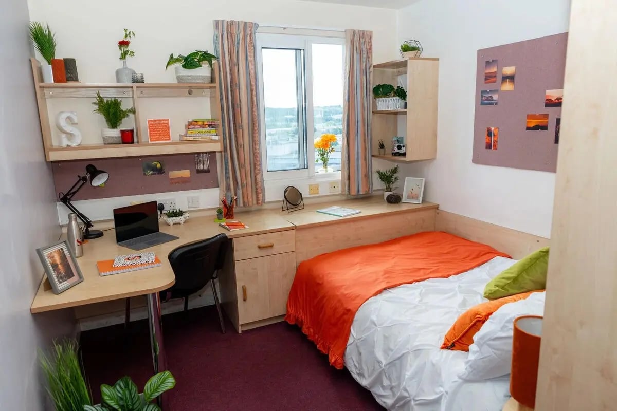 Desk laptop bed plants and shelves Bedroom at Wardley House Key Workers in Bradford Student Accommodation