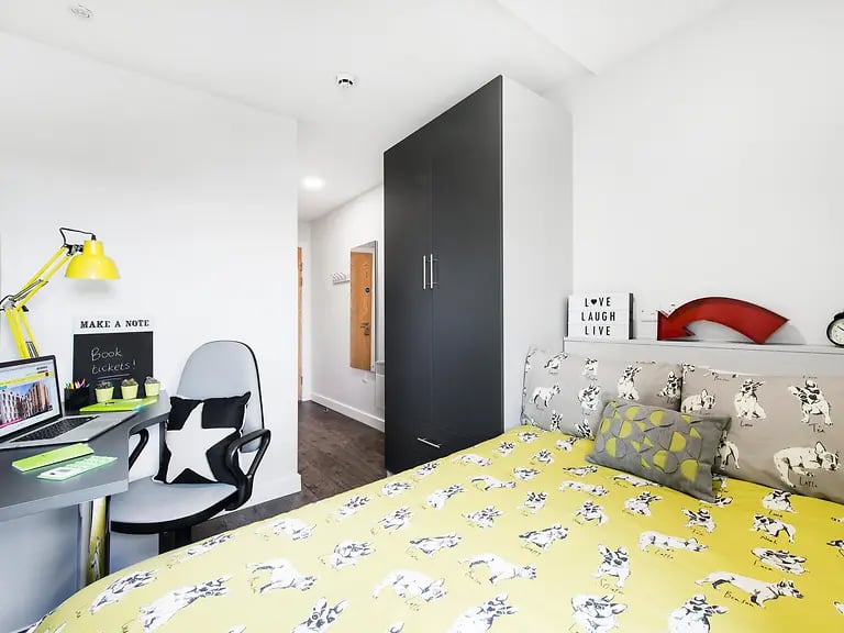 Desk lamp chair laptop and bed bedroom at Yugo Austen House in Southampton Student Accommodation
