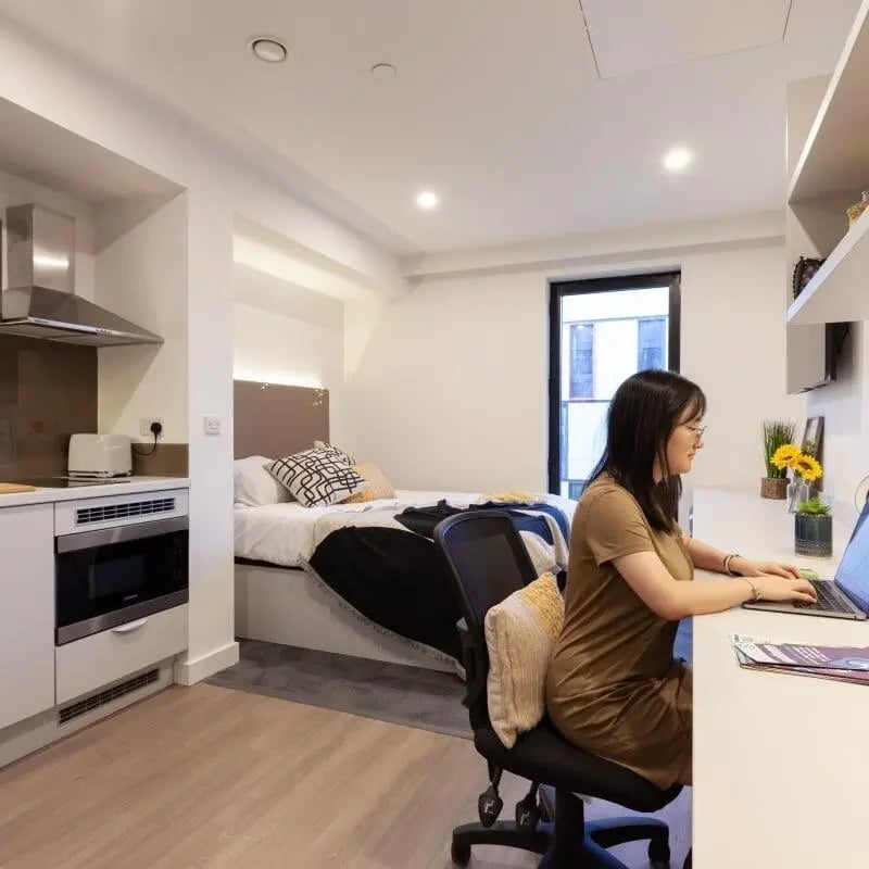 Kitchen bed desk and woman student accommodation bedroom at True Swansea in Swansea Student Accommodation